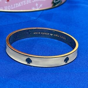 Kate Spade Gold Bangle with a Iight Cream Color Enamel